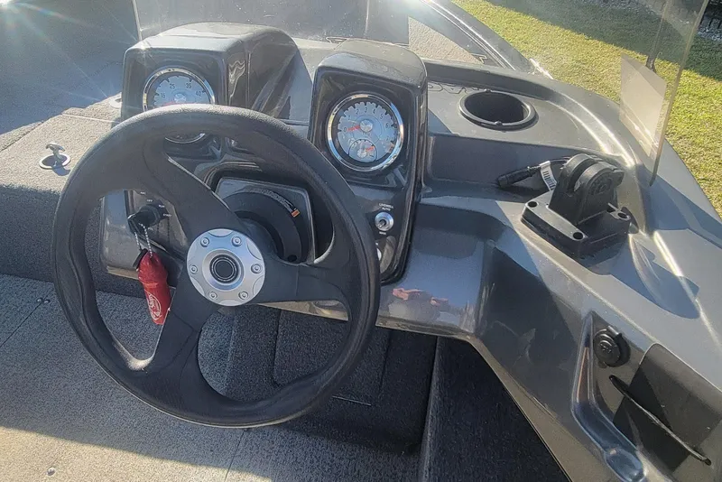 Slide: The Image of 2020 Tracker Pro Guide V-16 SC boat dashboard with steering wheel and gauges. - 15