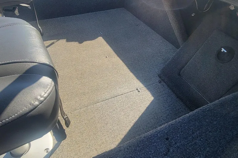 Slide: The Image of Interior of 2020 Tracker Pro Guide V-16 SC boat with carpeted flooring and seating. - 16