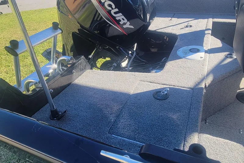 Slide: The Image of 2020 Tracker Pro Guide V-16 SC boat interior with Mercury engine and ladder. - 18