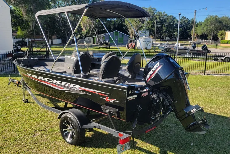 Slide: The Image of 2020 Tracker Pro Guide V-16 SC boat with Mercury engine on grassy area. - 4