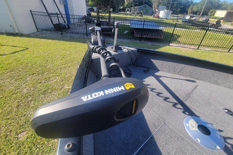 Slide: The Image of 2020 Tracker Pro Guide V-16 SC boat with Minn Kota trolling motor on grassy area. - 8
