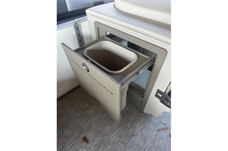 Slide: The Image of Pull-out storage compartment on 2026 Bennington 22 MFB boat interior. - 10