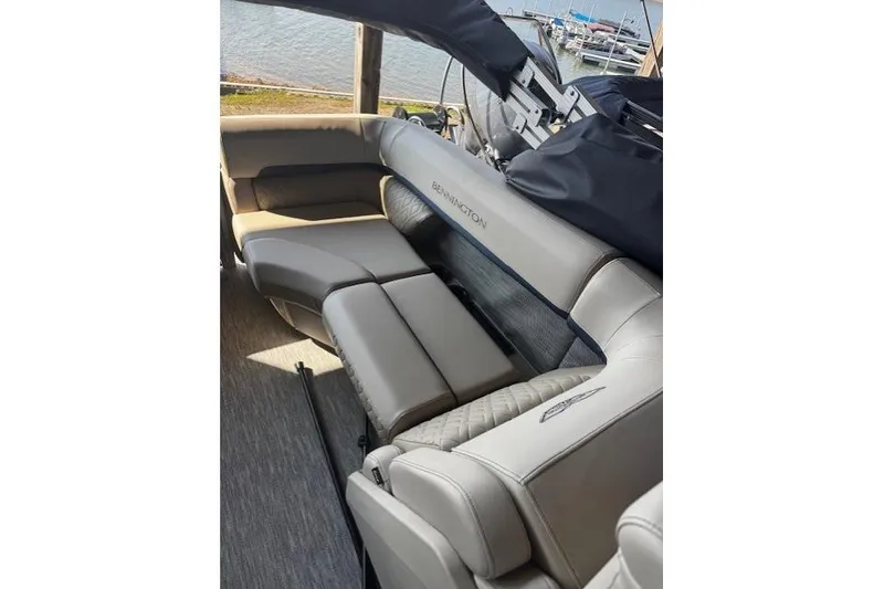 Slide: The Image of Luxurious seating on a 2026 Bennington 22 MFB boat, docked by the water. - 12
