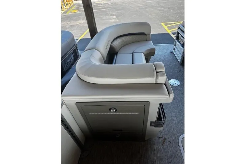 Slide: The Image of 2026 Bennington 22 MFB boat interior with plush seating and storage compartment. - 14