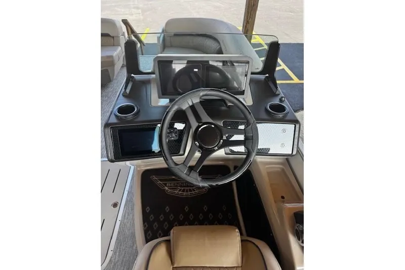 Slide: The Image of 2026 Bennington 22 MFB boat dashboard with steering wheel and digital display. - 15