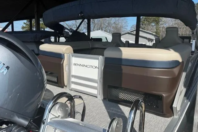Slide: The Image of 2026 Bennington 22 MFB pontoon boat interior with seating and motor. - 2