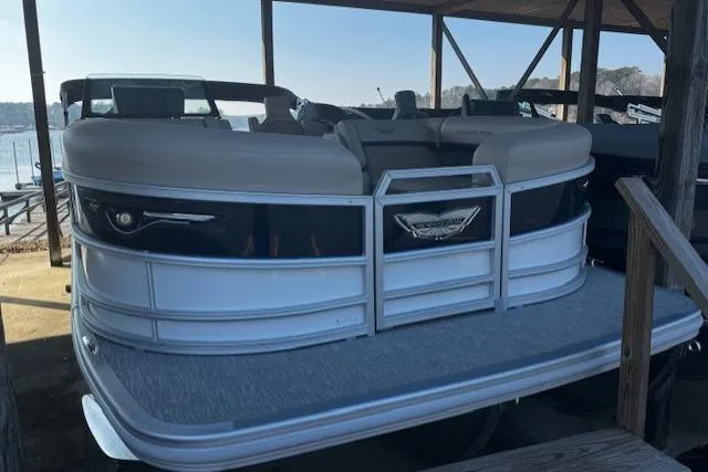 Slide: The Image of 2026 Bennington 22 MFB pontoon boat docked under a wooden shelter. - 4