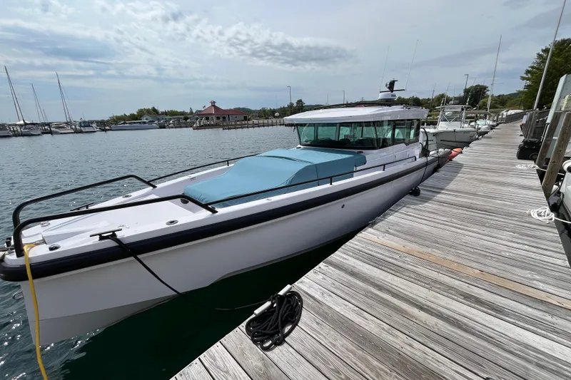 The Image of 2024 Axopar 37 XC Cross Cabin docked at a marina, showcasing sleek design. - 1