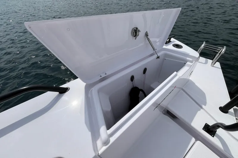 Slide: The Image of Open storage compartment on 2024 Axopar 37 XC Cross Cabin boat, docked on water. - 10