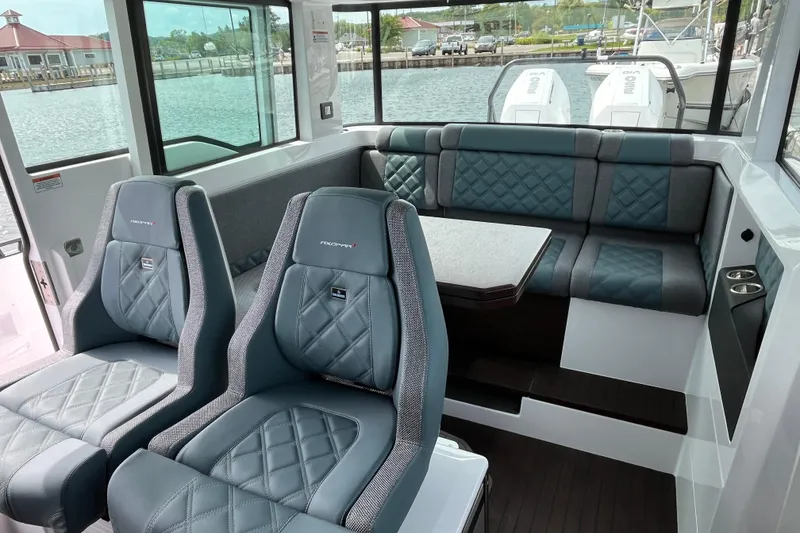 Slide: The Image of 2024 Axopar 37 XC Cross Cabin interior with stylish seating and table. - 13