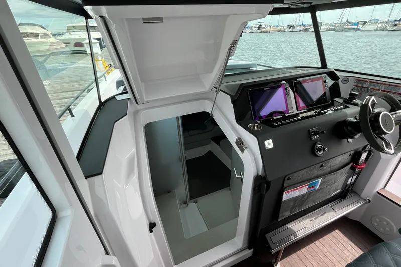 Slide: The Image of 2024 Axopar 37 XC Cross Cabin interior with helm and navigation screens. - 16