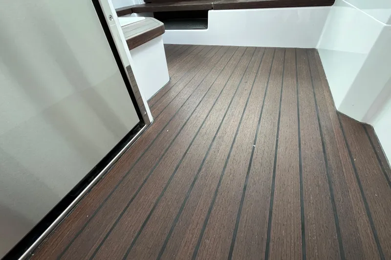 Slide: The Image of 2024 Axopar 37 XC Cross Cabin interior with sleek wooden flooring. - 19