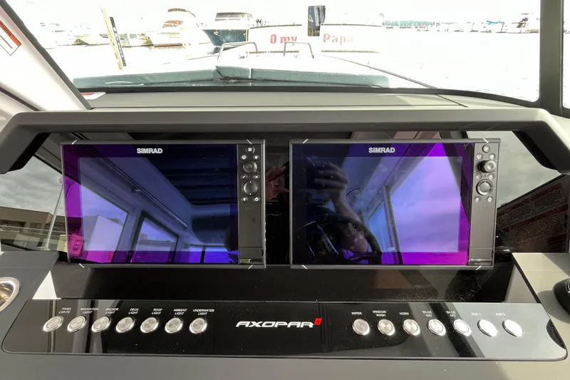 Slide: The Image of Dashboard of 2024 Axopar 37 XC Cross Cabin with dual Simrad displays. - 22