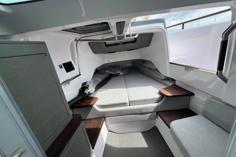 Slide: The Image of 2024 Axopar 37 XC Cross Cabin interior with modern seating and sleek design. - 24