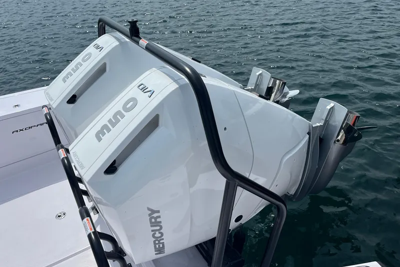 Slide: The Image of 2024 Axopar 37 XC Cross Cabin with twin Mercury outboard engines on water. - 3