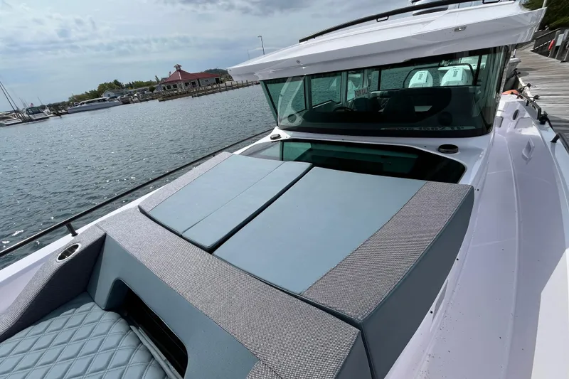 Slide: The Image of 2024 Axopar 37 XC Cross Cabin boat docked at marina, showcasing sleek design. - 6