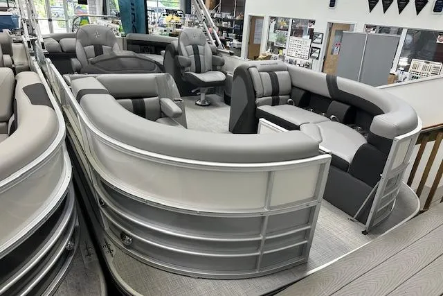 Slide: The Image of 2025 Berkshire 22RFX CTS pontoon boat with luxurious seating in showroom. - 14