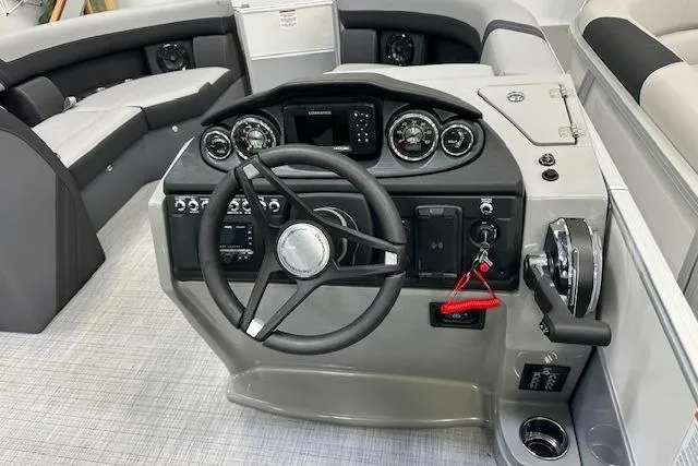 Slide: The Image of 2025 Berkshire 22RFX CTS boat dashboard with steering wheel and control panel. - 8