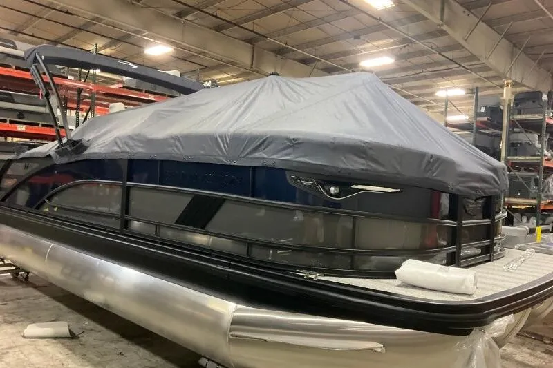 The Image of 2026 Bennington 22 MSB pontoon boat covered in a warehouse setting. - 0