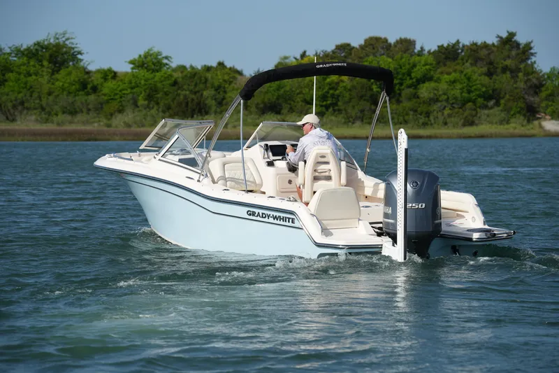 Slide: The Image of 2021 Grady-White Freedom 215 boat cruising on a serene lake. - 10