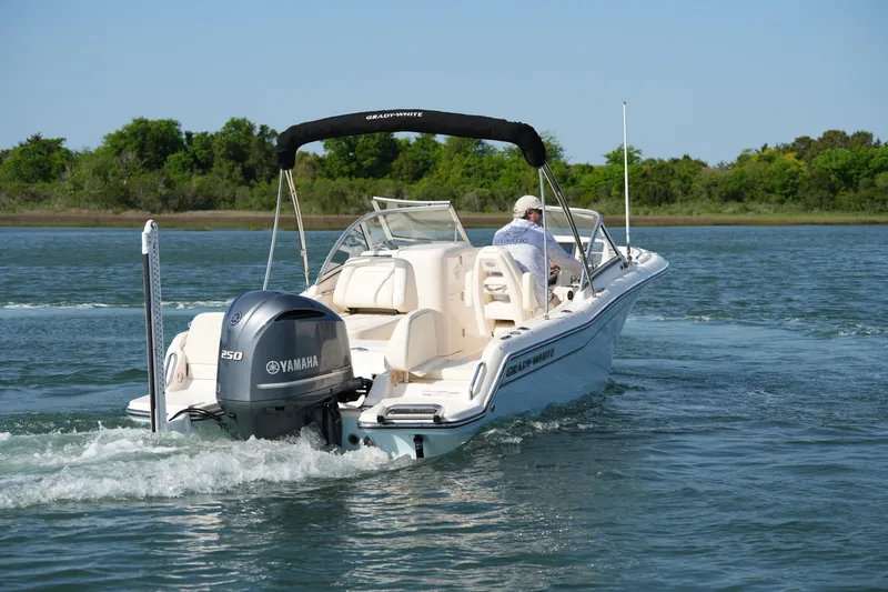 Slide: The Image of 2021 Grady-White Freedom 215 boat cruising on a calm lake with Yamaha engine. - 12