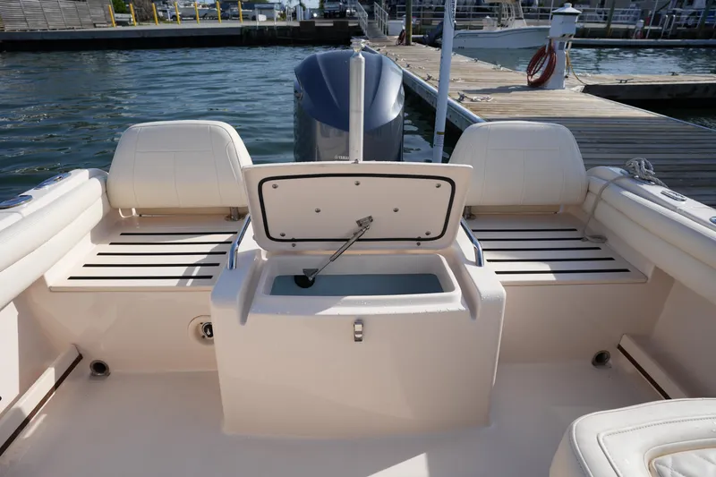 Slide: The Image of 2021 Grady-White Freedom 215 boat interior with open storage compartment at dock. - 16