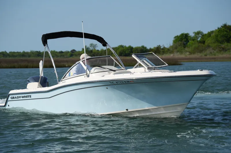 Slide: The Image of 2021 Grady-White Freedom 215 boat cruising on a calm lake. - 2