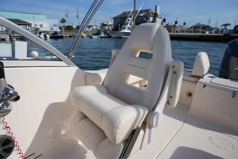 Slide: The Image of 2021 Grady-White Freedom 215 boat interior with luxurious seating and waterfront view. - 22