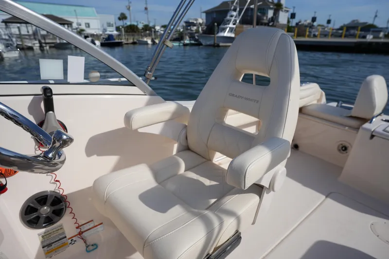 Slide: The Image of 2021 Grady-White Freedom 215 boat interior with helm seat and steering wheel. - 23