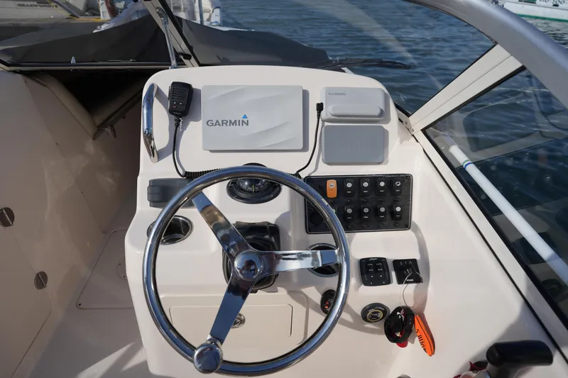 Slide: The Image of 2021 Grady-White Freedom 215 boat helm with Garmin navigation system and steering wheel. - 24