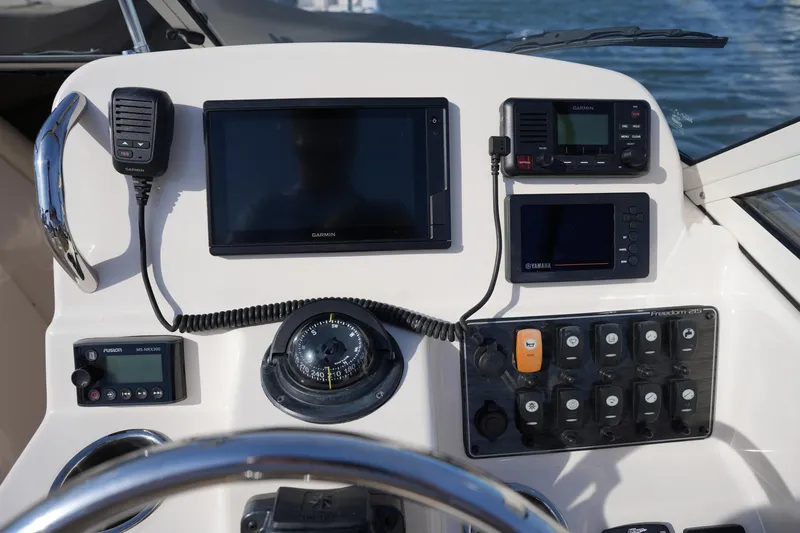 Slide: The Image of Control panel of 2021 Grady-White Freedom 215 boat with navigation and communication equipment. - 25