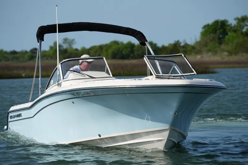 Slide: The Image of 2021 Grady-White Freedom 215 boat cruising on a calm lake. - 3