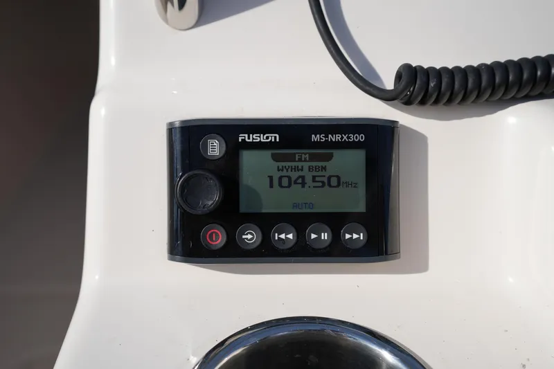 Slide: The Image of Fusion MS-NRX300 radio display on 2021 Grady-White Freedom 215 boat dashboard. - 31