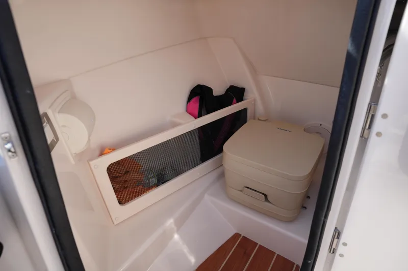Slide: The Image of Interior of 2021 Grady-White Freedom 215 boat with portable toilet and storage. - 36