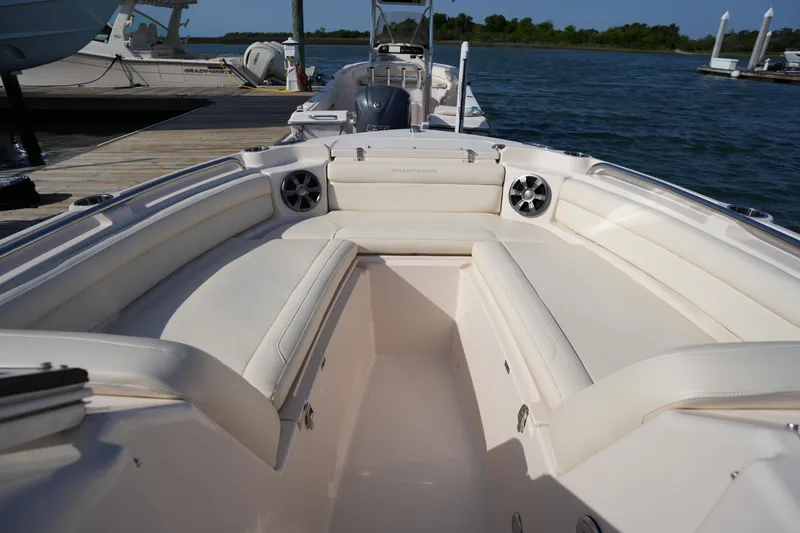 Slide: The Image of 2021 Grady-White Freedom 215 boat interior with white seating at dock. - 37