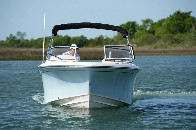 Slide: The Image of 2021 Grady-White Freedom 215 boat cruising on a calm lake. - 4