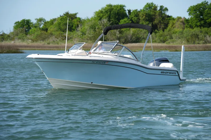 Slide: The Image of 2021 Grady-White Freedom 215 boat cruising on a serene lake. - 6