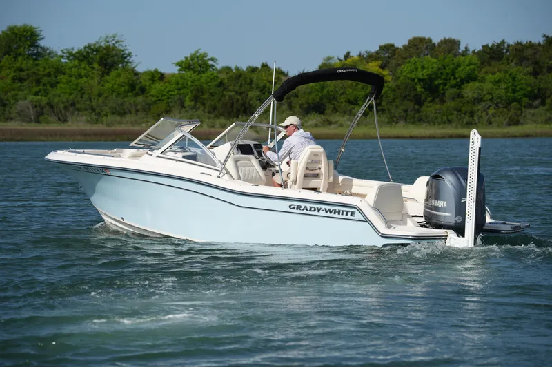 Slide: The Image of 2021 Grady-White Freedom 215 boat cruising on a serene lake. - 9