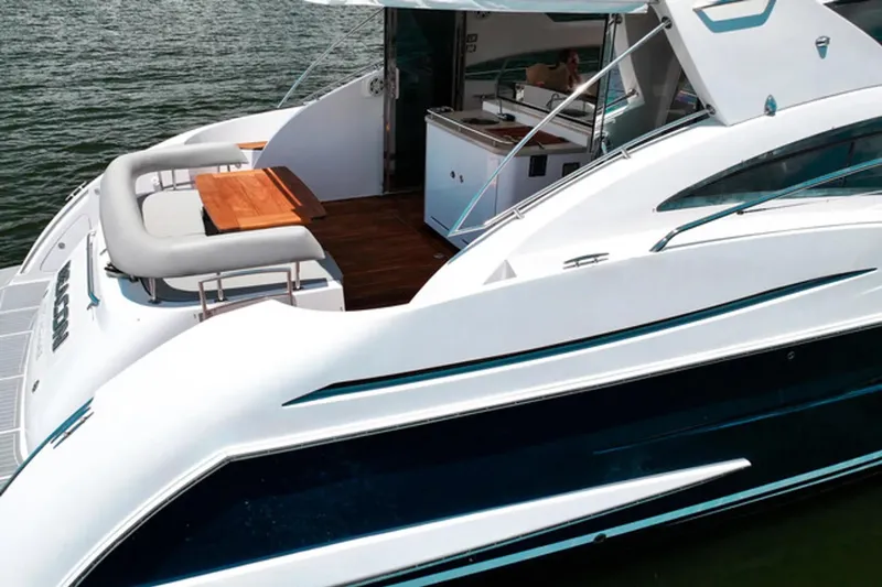 Slide: The Image of Luxurious 2008 Savannah 54 yacht with sleek design and spacious deck on the water. - 2