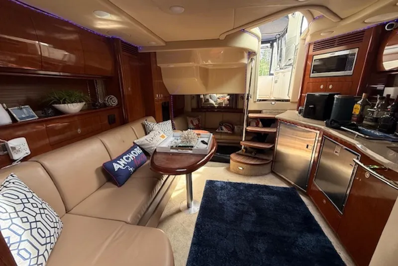 Slide: The Image of Luxurious interior of a 2004 Sea Ray 390 Sundancer yacht with elegant seating and kitchenette. - 11
