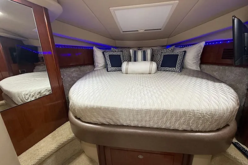 Slide: The Image of Luxurious cabin interior of 2004 Sea Ray 390 Sundancer with elegant bedding and ambient lighting. - 13