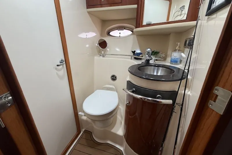 Slide: The Image of Luxurious bathroom in 2004 Sea Ray 390 Sundancer yacht with modern fixtures and wood accents. - 14
