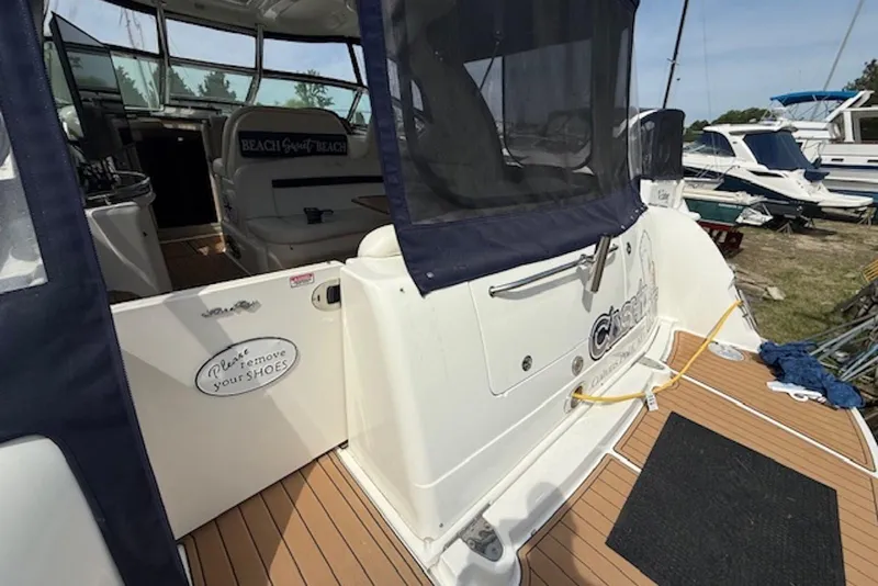 Slide: The Image of 2004 Sea Ray 390 Sundancer yacht with open cockpit and "Please remove your shoes" sign. - 3