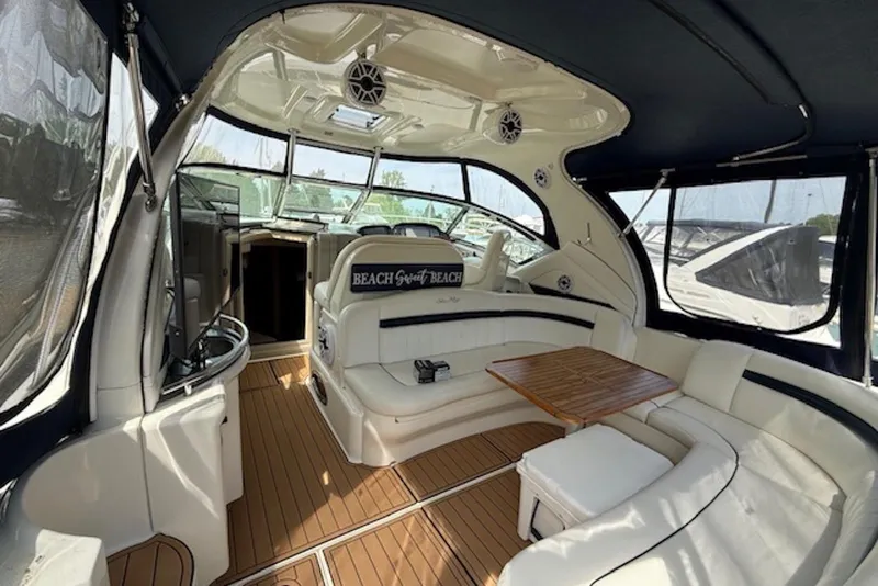 Slide: The Image of Interior of 2004 Sea Ray 390 Sundancer yacht with luxurious seating and wooden table. - 4