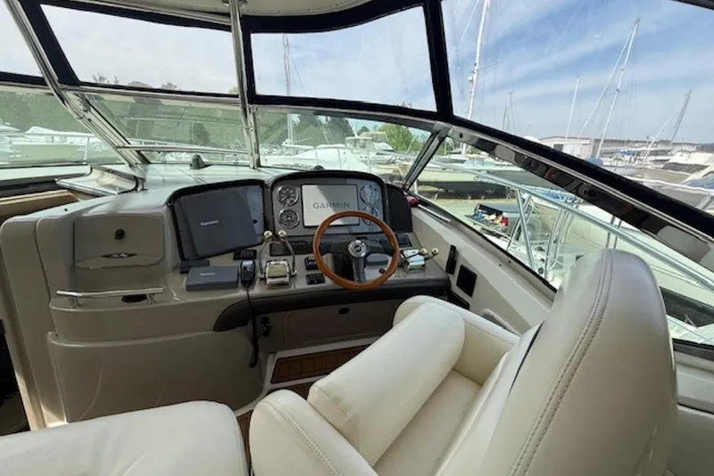 Slide: The Image of Cockpit of 2004 Sea Ray 390 Sundancer with navigation equipment and leather seating. - 5