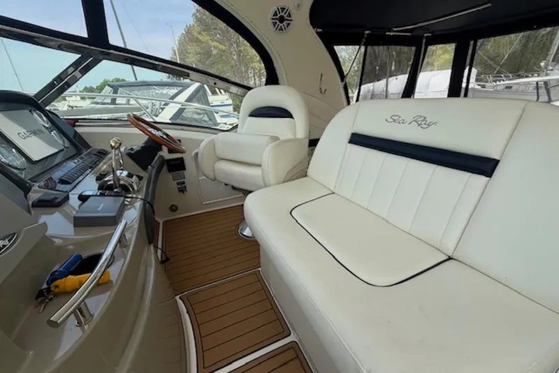 Slide: The Image of Interior of 2004 Sea Ray 390 Sundancer yacht with white seating and control panel. - 6