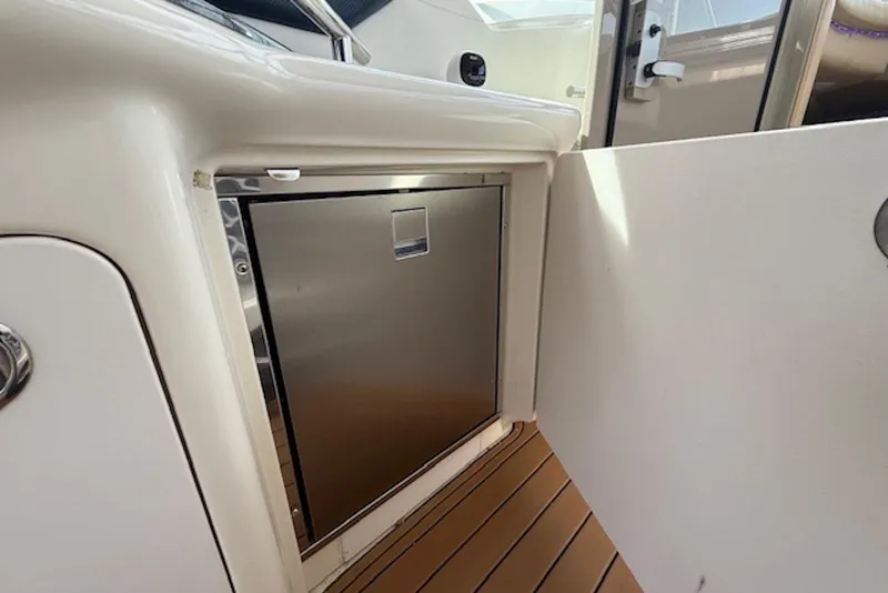 Slide: The Image of 2004 Sea Ray 390 Sundancer interior with stainless steel cabinet and wooden flooring. - 8