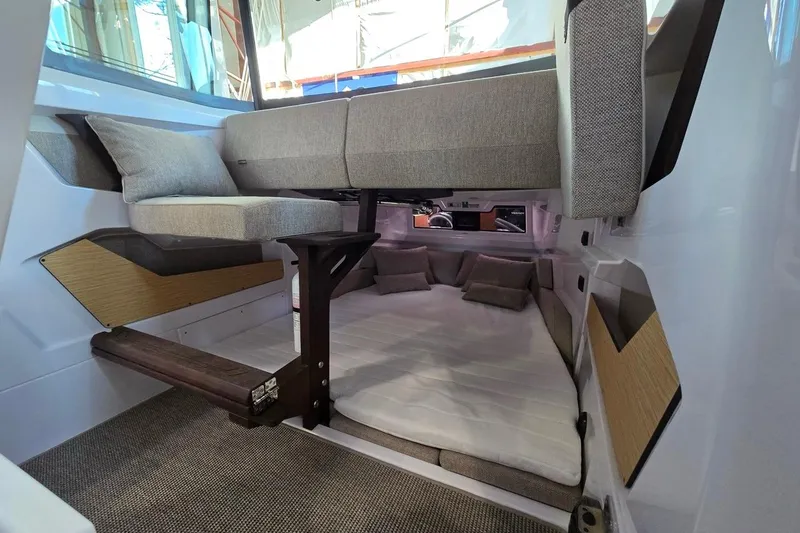 Slide: The Image of 2026 Axopar 29 XC Cross Cabin interior with cozy seating and modern design. - 11