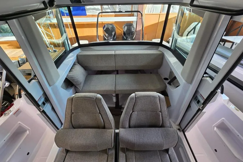 Slide: The Image of 2026 Axopar 29 XC Cross Cabin interior with modern seating and panoramic windows. - 12