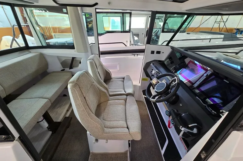 Slide: The Image of 2026 Axopar 29 XC Cross Cabin interior with modern seating and advanced dashboard. - 14